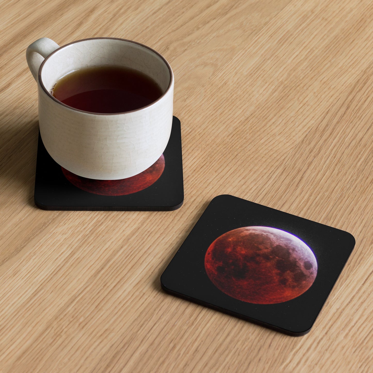 An artisan coaster titled 'Blood Moon' by Warlock Photography, featuring a high-detail photograph of a lunar eclipse with a deep crimson moon against a black space background.