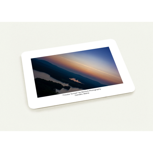 Close-up of 'Tricolor Sunset' postcards on premium paper, highlighting the crisp contrail and atmospheric mist of a Maine valley at dus